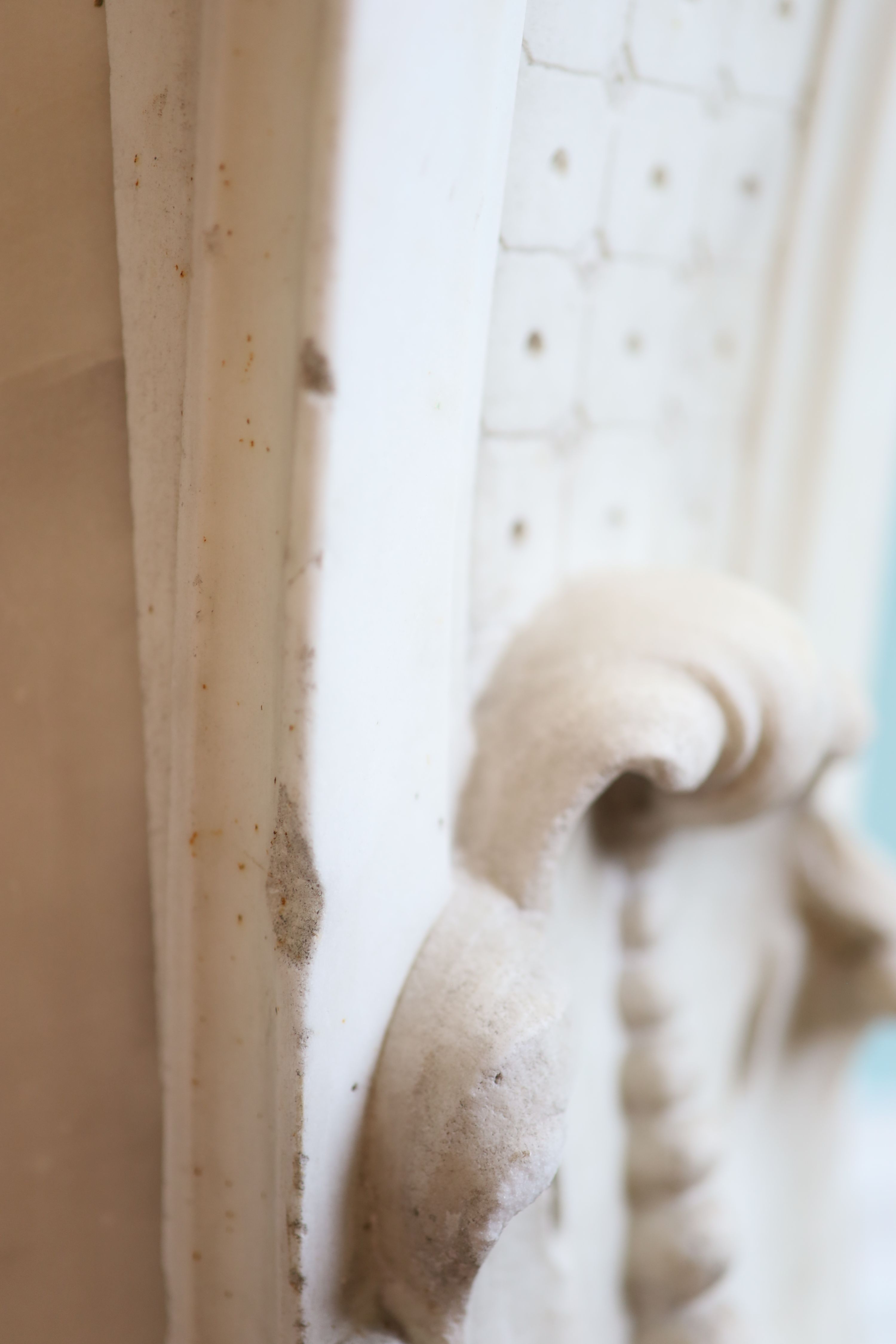 An important mid 19th century Italian white Carrara marble chimney piece, carved in the rococo taste, with seated putti, foliage swags